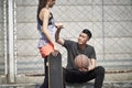 Young asian man and woman bumping fists outdoors