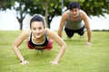 Young asian man and woman doing push-ups Royalty Free Stock Photo