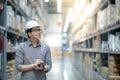 Asian man doing stocktaking by using tablet in warehouse Royalty Free Stock Photo