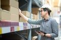 Asian man doing stocktaking by using tablet in warehouse Royalty Free Stock Photo