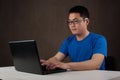 Young asian man working on his laptop computer Royalty Free Stock Photo