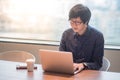 Young Asian man working with laptop computer in office Royalty Free Stock Photo