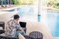 Young Asian man working with laptop computer. Social distancing from Coronavirus or Covid-19 outbreak. Social distancing concept Royalty Free Stock Photo