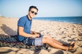 Young asian man working with laptop computer on tropical beach . Tourist Royalty Free Stock Photo