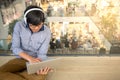 Young Asian man working with laptop while listening to music Royalty Free Stock Photo