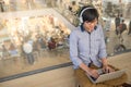 Young Asian man working with laptop while listening to music Royalty Free Stock Photo