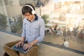 Young Asian man working with laptop while listening to music Royalty Free Stock Photo