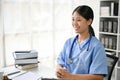 Young Asian medical student smiling and sitting in the study room Royalty Free Stock Photo