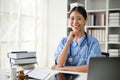 Young Asian medical student smiling and sitting in the study room Royalty Free Stock Photo