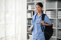 Young Asian medical student smiling and standing in the study room Royalty Free Stock Photo