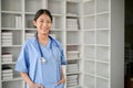 Young Asian medical student smiling and standing in the study room Royalty Free Stock Photo