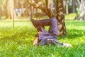 Young asian men lies on green moss relaxing with eyes closed and hands behind his head, feeling comfortable on the grass field Royalty Free Stock Photo