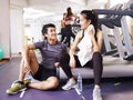 Asian young people talking in gym Royalty Free Stock Photo