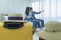 Young Asian man and women are preparing for the journey happily. Young couple relaxing In room looking out of window Royalty Free Stock Photo