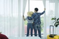 Young Asian man and women are preparing for the journey happily. Young couple relaxing In room looking out of window Royalty Free Stock Photo