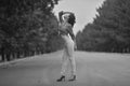 Young asian model teenager in a hippie style posing on the freeway. Black-white photo Royalty Free Stock Photo