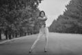 Young asian model teenager in a hippie style posing on the freeway. Black-white photo Royalty Free Stock Photo