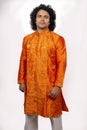 Young asian model wearing orange kurta