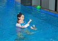 Young Asian mom teaching baby boy in swimming pool Royalty Free Stock Photo