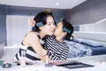 Young asian mother and daughter with hair curlers are spending quality time at home Royalty Free Stock Photo