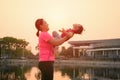 Young asian mother in a gym suit with a cute daughter is relaxing and happy in the park Royalty Free Stock Photo