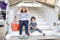 Young mother with her son sitting on the stairs