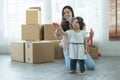 Young Asian mother holding hand little cute Caucasian daughter making soap bubbles, looking at soap bubbles in the air with Royalty Free Stock Photo