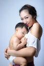 Young asian mother holding her baby and breast feeding baby Royalty Free Stock Photo