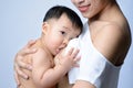 Young asian mother holding her baby and breast feeding baby Royalty Free Stock Photo