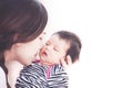 Young asian mother hugging and kissing her newborn baby girl Royalty Free Stock Photo