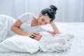 Young Asian mother lie on white bed and take care her newborn baby Royalty Free Stock Photo