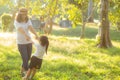 Young asian mother and little daughter playing the park with fun and happiness, family enjoy and relax and leisure together Royalty Free Stock Photo