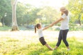 Young asian mother and little daughter playing the park with fun and happiness, family enjoy and relax and leisure together Royalty Free Stock Photo