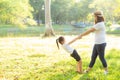 Young asian mother and little daughter playing the park with fun and happiness, family enjoy and relax and leisure together Royalty Free Stock Photo