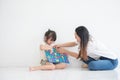 Young Asian mother taught her little daughter about reading English characters, having fun together, family concept