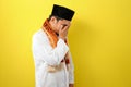 Young Asian Muslim man feel sad with covering his face with hands. Copy space concept Royalty Free Stock Photo