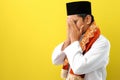 Young Asian Muslim man feel sad with covering his face with hands. Copy space concept Royalty Free Stock Photo