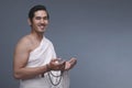 Young asian muslim man in ihram holding prayer beads Royalty Free Stock Photo