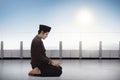 Young asian muslim man with traditional dress praying Royalty Free Stock Photo