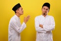 Young Asian Muslim men ignore the apologize of his Muslim`s brother. Bad Attitude in Ramadan