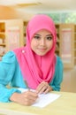 Young asian muslim woman in head scarf smile busy studying Royalty Free Stock Photo