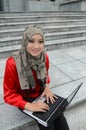 Young asian muslim woman in head scarf surf internet Royalty Free Stock Photo