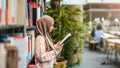 Young asian muslim woman reading book in a library Royalty Free Stock Photo