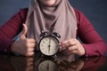 Muslim Woman Holding Clock Pointing at Six O& x27;Clock Royalty Free Stock Photo