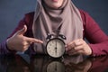 Muslim Woman Holding Clock Pointing at Six O& x27;Clock Royalty Free Stock Photo