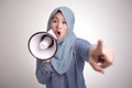 Asian muslim woman Shouting with Megaphone, Leader, Supporter or Protester Royalty Free Stock Photo