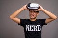 Young Asian nerd man using virtual reality headset Royalty Free Stock Photo