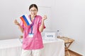 Young asian nurse woman at political campaign election holding russia flag screaming proud, celebrating victory and success very Royalty Free Stock Photo