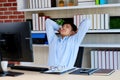 Young asian office man stretching body for relaxing while working with computer at his desk, office lifestyle, business situation Royalty Free Stock Photo