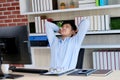 Young asian office man stretching body for relaxing while working with computer at his desk, office lifestyle, business situation Royalty Free Stock Photo
